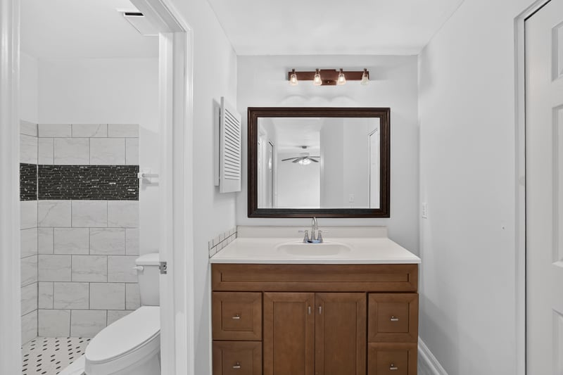 Bathroom with wood vanity and tub at 3801 Crown Point Rd unit 2061, Jacksonville, FL 32257
