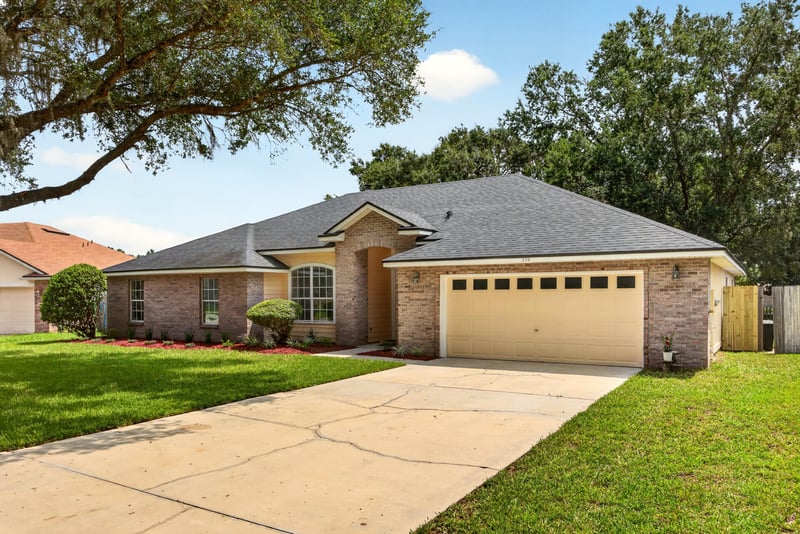 Front exterior close view of driveway and entry at 456 Bay Point Way N, Jacksonville, FL 32259