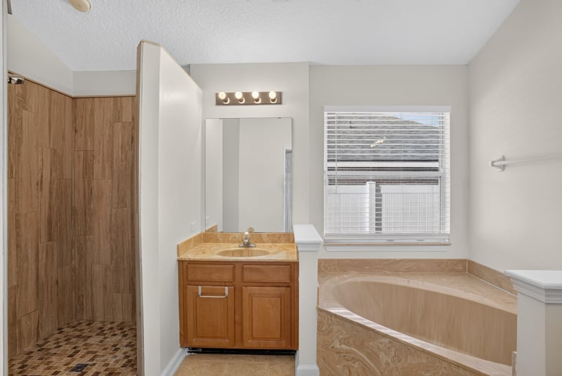 Primary bathroom shower and vanity at 299 John's Creek Pkwy, St. Augustine, FL 32092