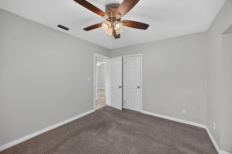 Bedroom, carpet and double closet at 2256 Inwood Cir S, Jacksonville, FL