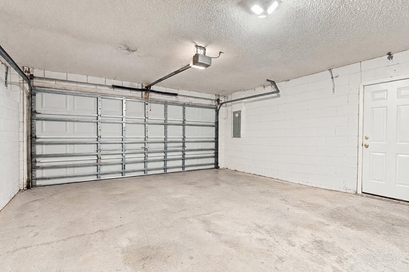 Two-car garage interior with overhead door at 11197 Illford Dr