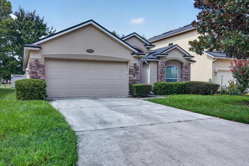 Front exterior closeup of garage doors and driveway at 469 Glendale Ln, Orange Park, FL