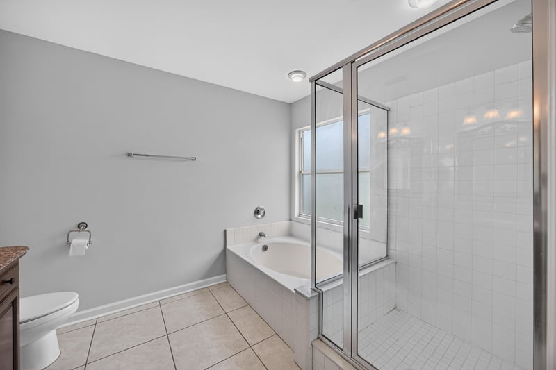 Bathroom with soaking tub and glass shower at 456 Bay Point Way N, Jacksonville, FL 32259