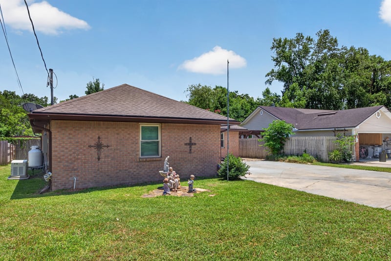 Front exterior angle with brick facade and landscaping at 2460 San Sago Ln, Jacksonville, FL