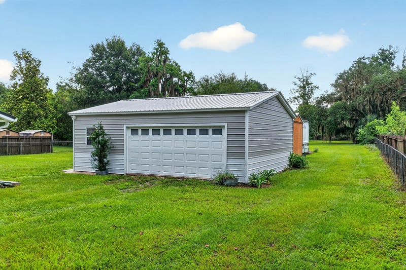 Detached garage exterior with gray door at 1619 Hammond Blvd, Jacksonville, FL