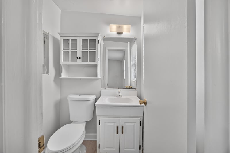 Bathroom with white vanity and mirrored cabinet at 87 Saratoga Cir S, Atlantic Beach, FL