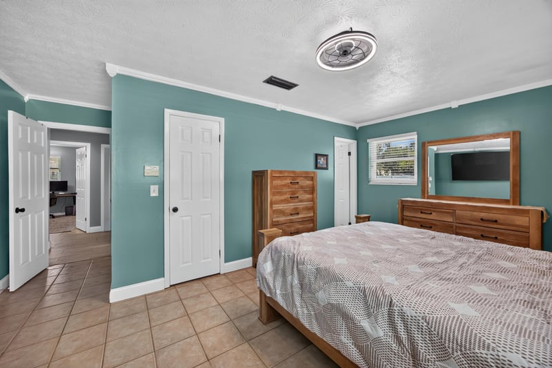 Bedroom with teal walls and wood dresser at 6059 Karen St, Jacksonville, FL 32244