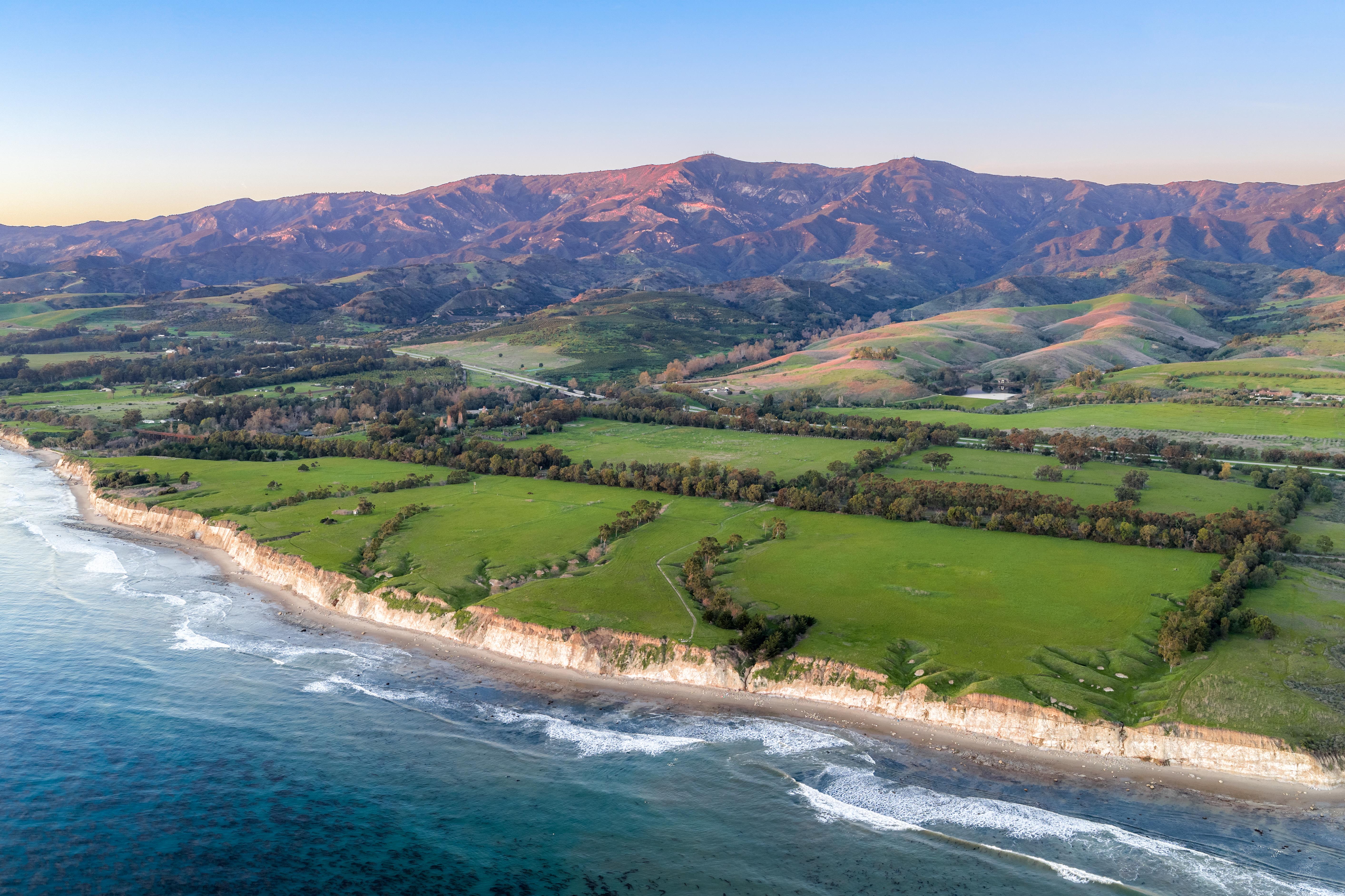Real estate drone photography elevated perspective of Naples Access Rd, Goleta — Montecito foothills and coastal landscape by VirTour Media