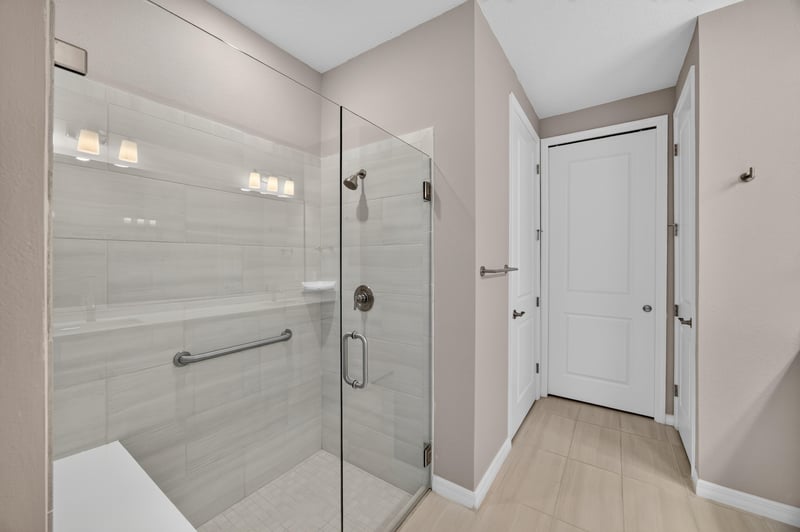 Glass-enclosed shower in the primary bathroom at 171 Oyster Shell Ter, Nocatee, FL 32081