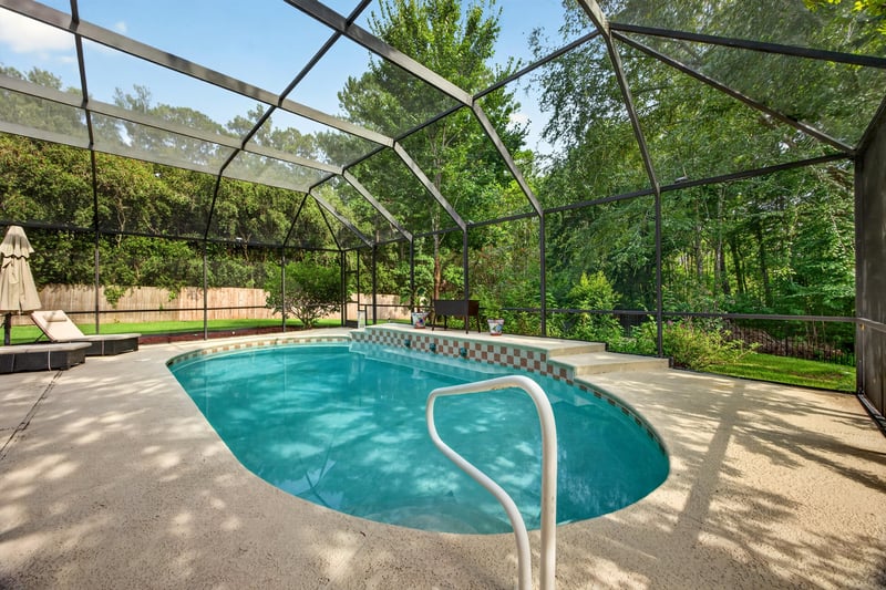 Pool with steps and screened enclosure at 2125 Blue Heron Cove Dr, Orange Park, FL 32003