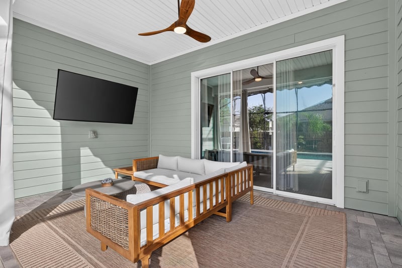 Covered patio with outdoor TV and sliding doors at 3328 Southern Oaks Dr, Green Cove Springs, FL 32043