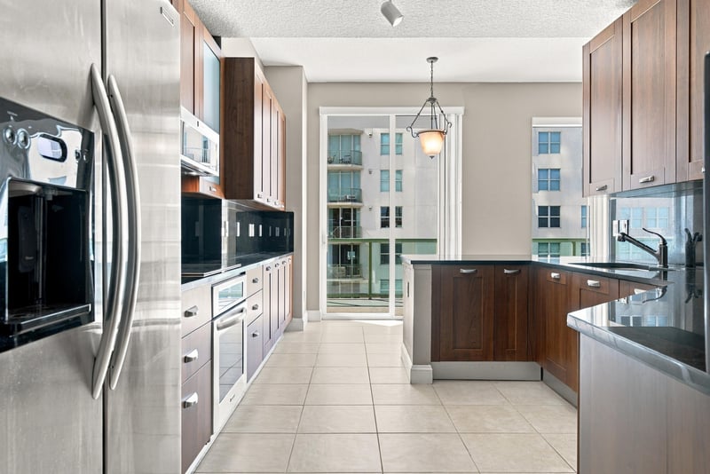 Kitchen with wood cabinetry and stainless appliances, photographed by Megapixeler on Riverplace Blvd, Jacksonville