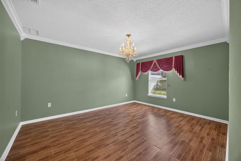 Empty dining room with chandelier and hardwood floor at 2282 Justin Lake Dr, Jacksonville, FL