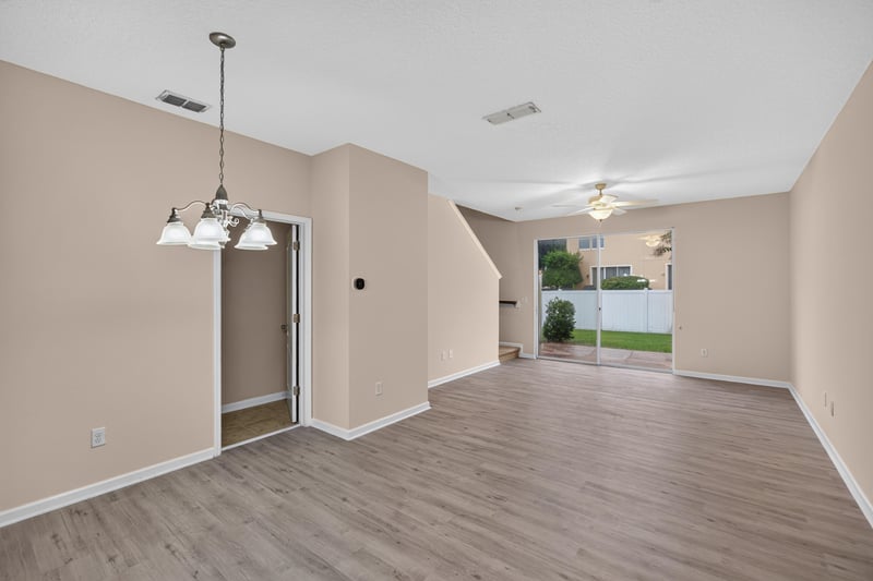 Dining area with chandelier opening to living room at 3762 Hartsfield Forest Cir, Jacksonville, FL 32277