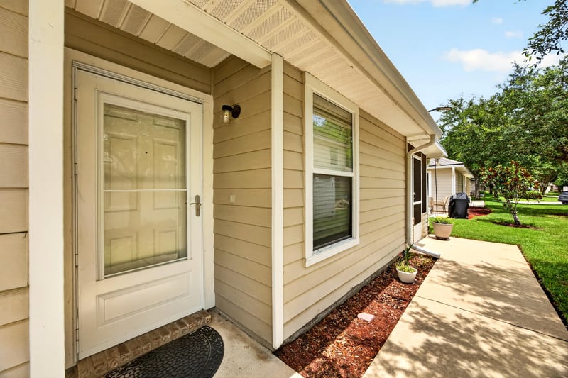Front door with sidelight window at 605 N Covered Bridge Rd, Jacksonville, FL