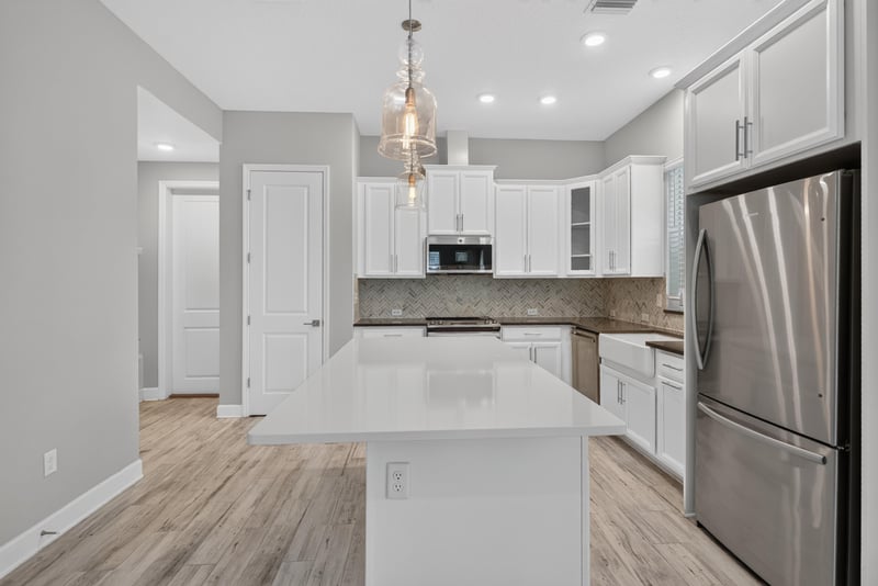 Kitchen island with white countertops at 7446 Loggerhead Ct, Jacksonville, FL 32256