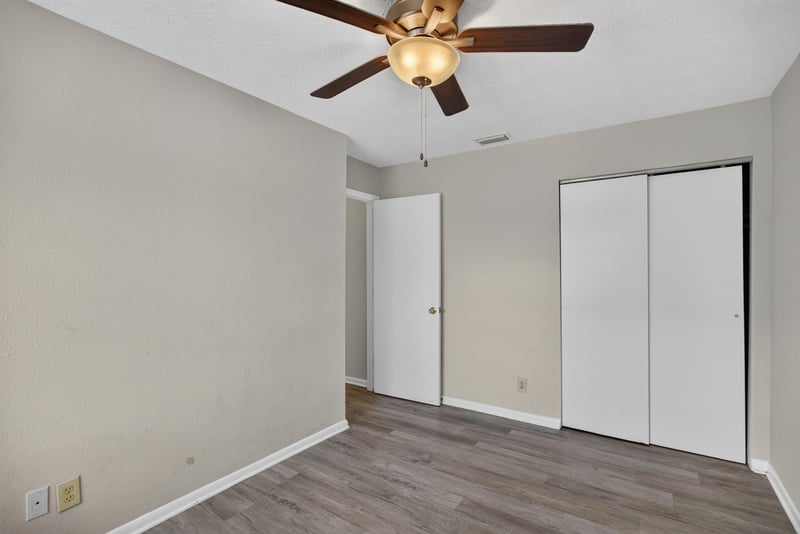 Bedroom with closet doors and wood-look flooring at 2658 Trollie Ln apt 1, Jacksonville, FL 32211