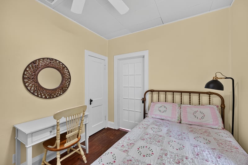 Bedroom with iron bed frame and desk at 101 N Lake St, Crescent City, FL