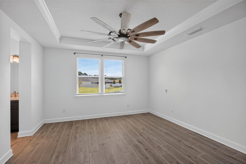 Bedroom with wood floors and window at 855 Flach Dr, St. Johns, FL