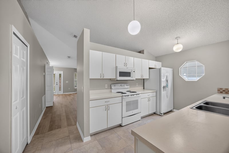 Kitchen view toward living area at 1845 Saga Ct, Middleburg, FL