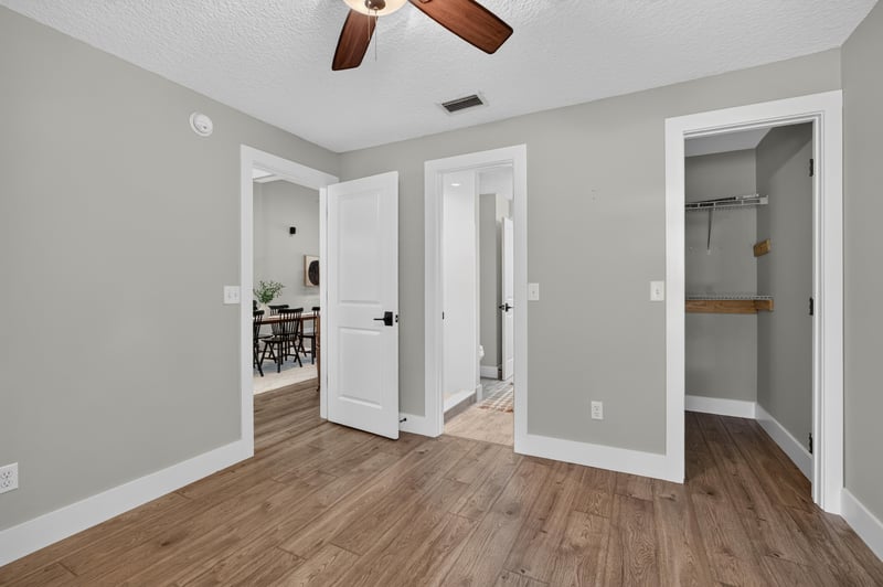 Hallway with wood floors leading to rooms at 1161 Whispering Pines Rd, Jacksonville, FL 32259