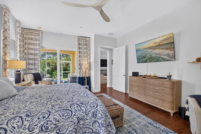 Bedroom with wall-mounted TV and wood dresser at 140 Ave De La Mer, Palm Coast, FL 32137