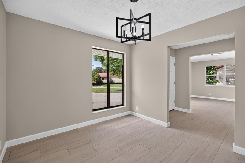 Empty open living space with window and pendant light at 4117 Wilcrest Ct, Jacksonville, FL 32277