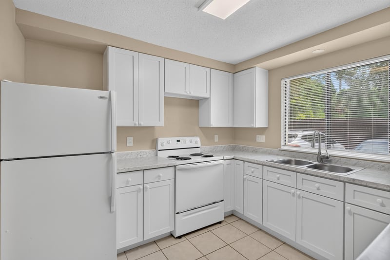 Kitchen with white appliances and window at 5811 Atlantic Blvd unit 47, Jacksonville, FL 32207