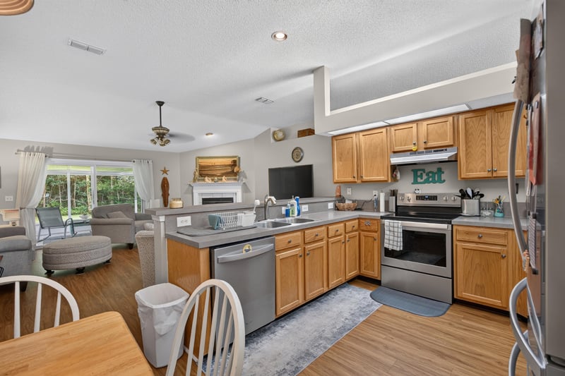 Wide view of open-concept living room and kitchen at 13514 Las Brisas Way N, Jacksonville, FL