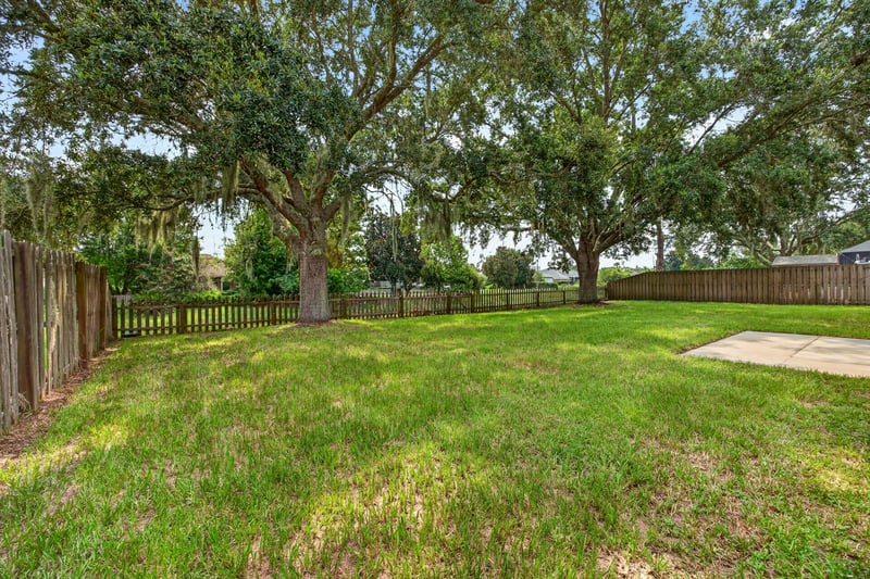 Backyard view with fencing and shade trees at 456 Bay Point Way N, Jacksonville, FL 32259