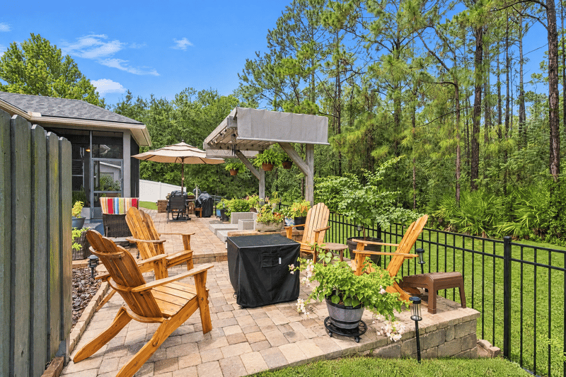 Backyard fire pit and pergola seating area at 10923 Black Diamond Ct, Jacksonville, FL