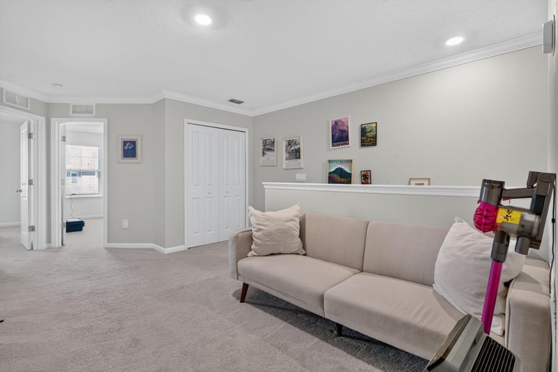 Upstairs hallway with bedroom doors at 1186 Beach Dune Dr, Jacksonville, FL 32233
