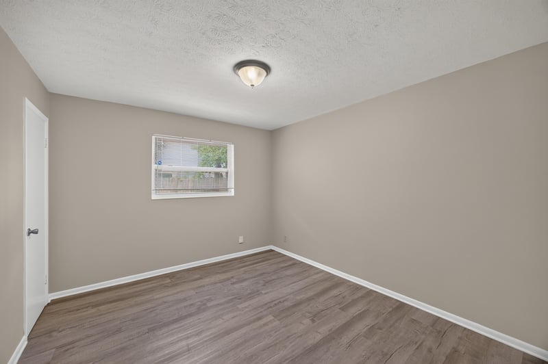 Bedroom with wood-look flooring and window at 5527 Beney Rd, Jacksonville, FL 32207