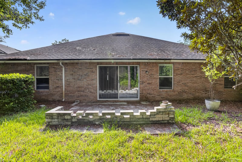 Backyard patio area with brick exterior at 299 John's Creek Pkwy, St. Augustine, FL 32092