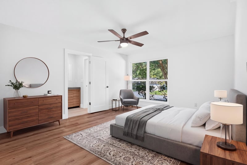 Bedroom with staged bed, dresser, and mirror at 8453 Boysenberry Ln W, Jacksonville, FL