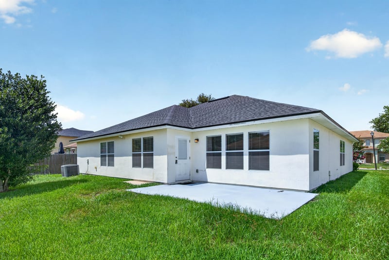 Back exterior with open lawn at 2282 Justin Lake Dr, Jacksonville, FL