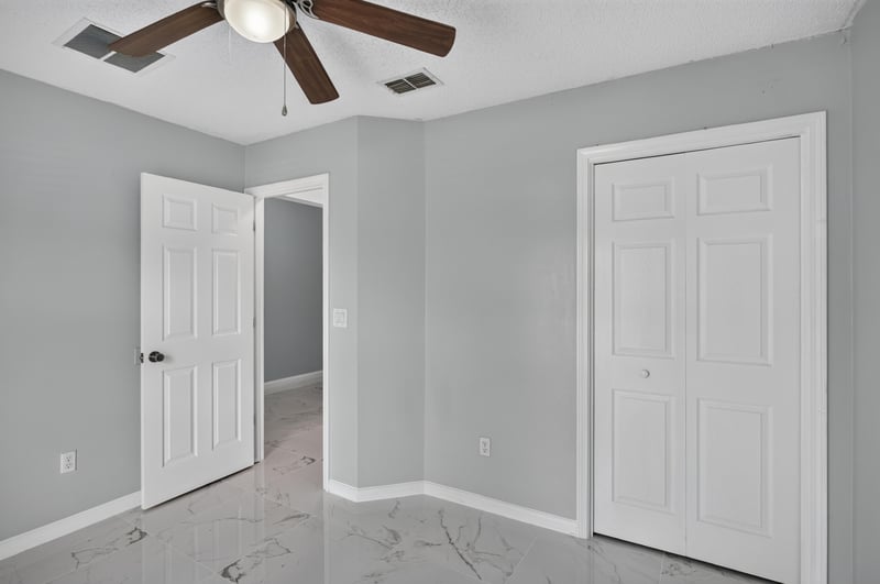 Bedroom with ceiling fan and closet door at 490 Hillside Dr, Orange Park, FL 32073
