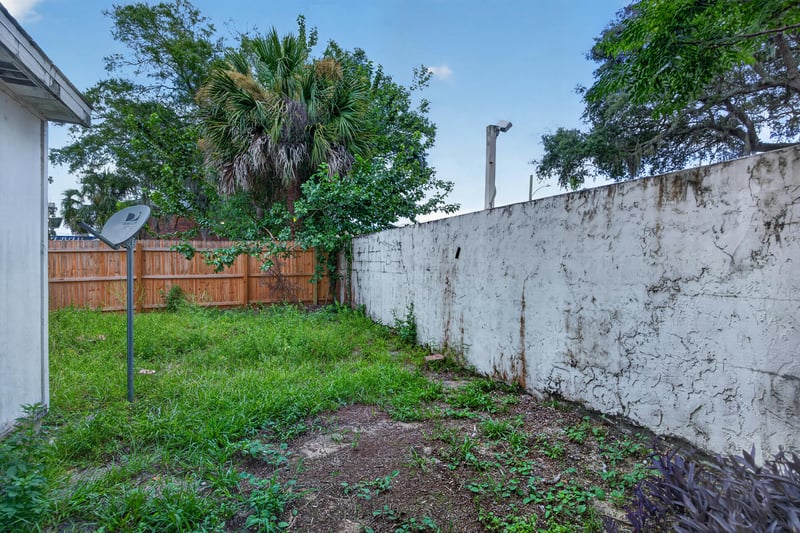Backyard lawn with wood fence and masonry wall at 2658 Trollie Ln apt 1, Jacksonville, FL 32211