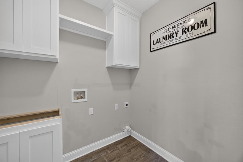 Laundry room with cabinetry and Self Service Laundry Room sign at 53 Lumen Ct, St. Augustine, FL 32095