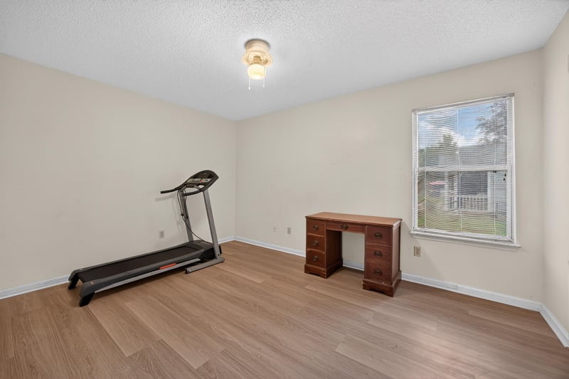 Bonus room with laminate floor and treadmill at 5375 Dodge Rd, Jacksonville, FL 32209