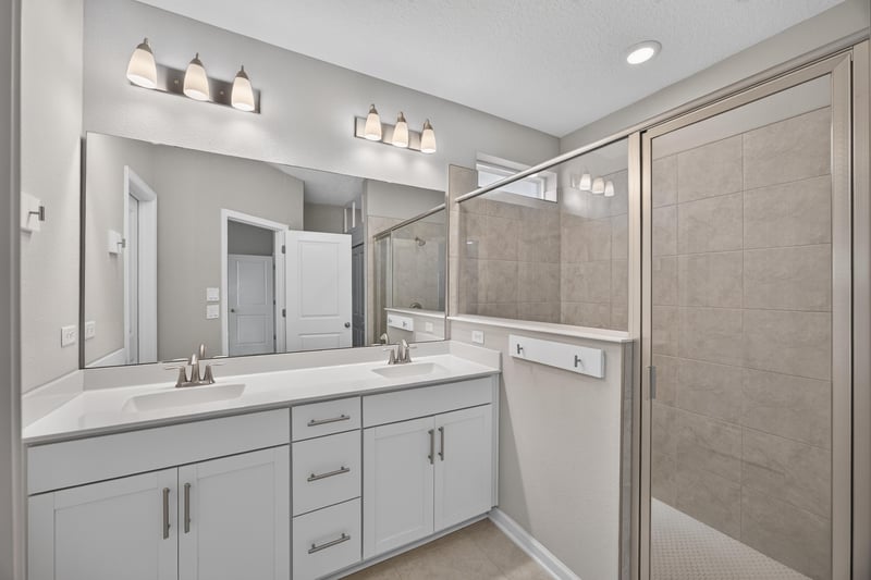 Bathroom with double vanity and walk-in shower at 75875 Saffron Ln, Yulee, FL 32097