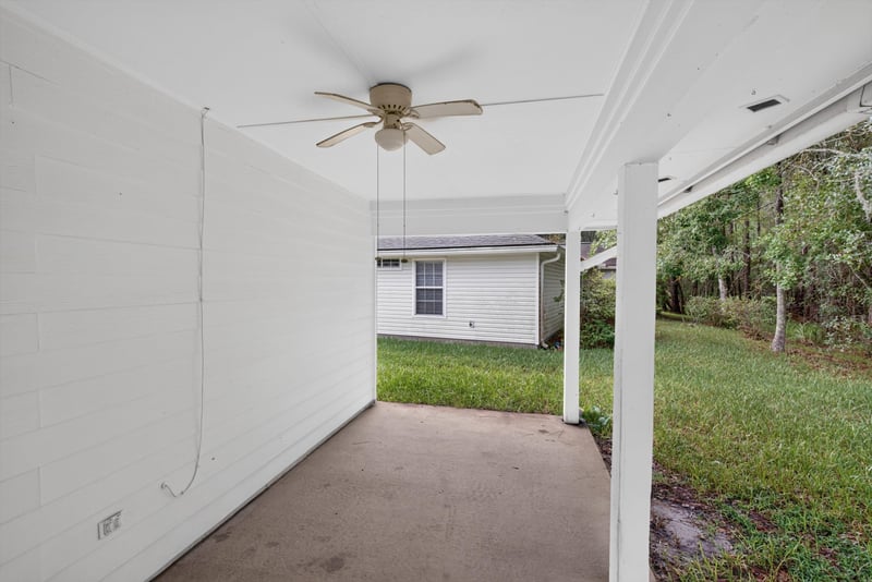 Covered back porch with view to the yard at 11669 Collins Creek Dr, Jacksonville, FL 32258