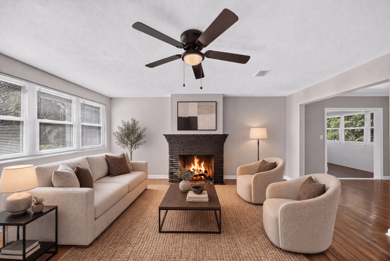 Living room with brick fireplace and staged seating at 6338 Mercer Cir W, Jacksonville, FL