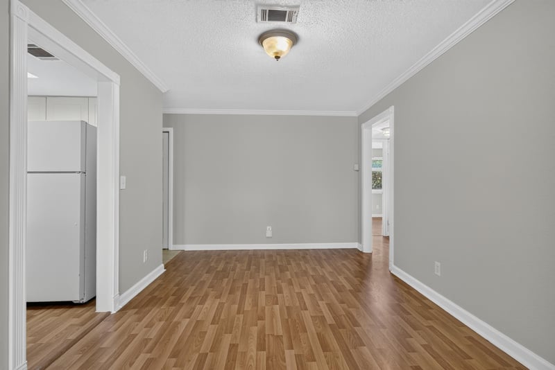 Room with white refrigerator and wood laminate floor at 3866 Campenero Ct unit 6, Jacksonville, FL 32217