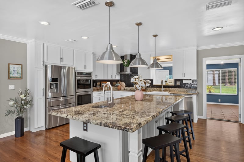Kitchen island with bar seating and pendant lighting at 5843 Ovella Rd, Jacksonville, FL 32244