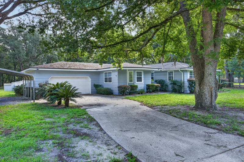 Front exterior with driveway and mature oak tree at 892 Branscomb Rd, Green Cove Springs, FL