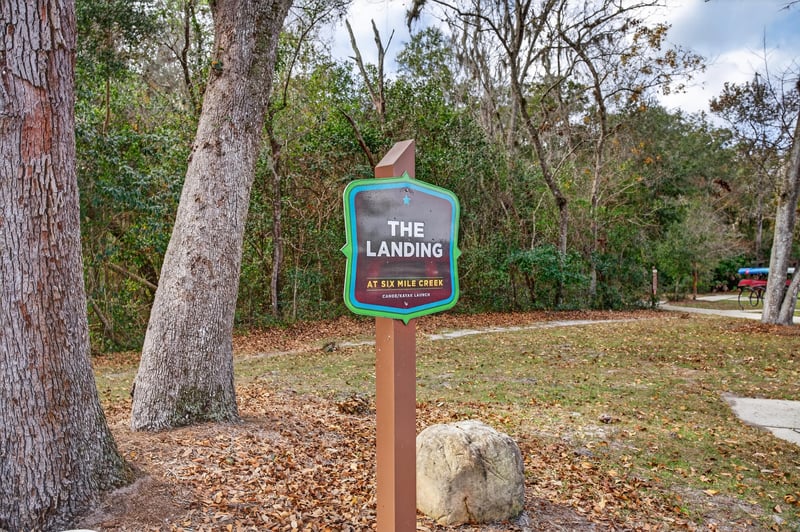 Trail entrance sign reading The Landing in Whisper Creek