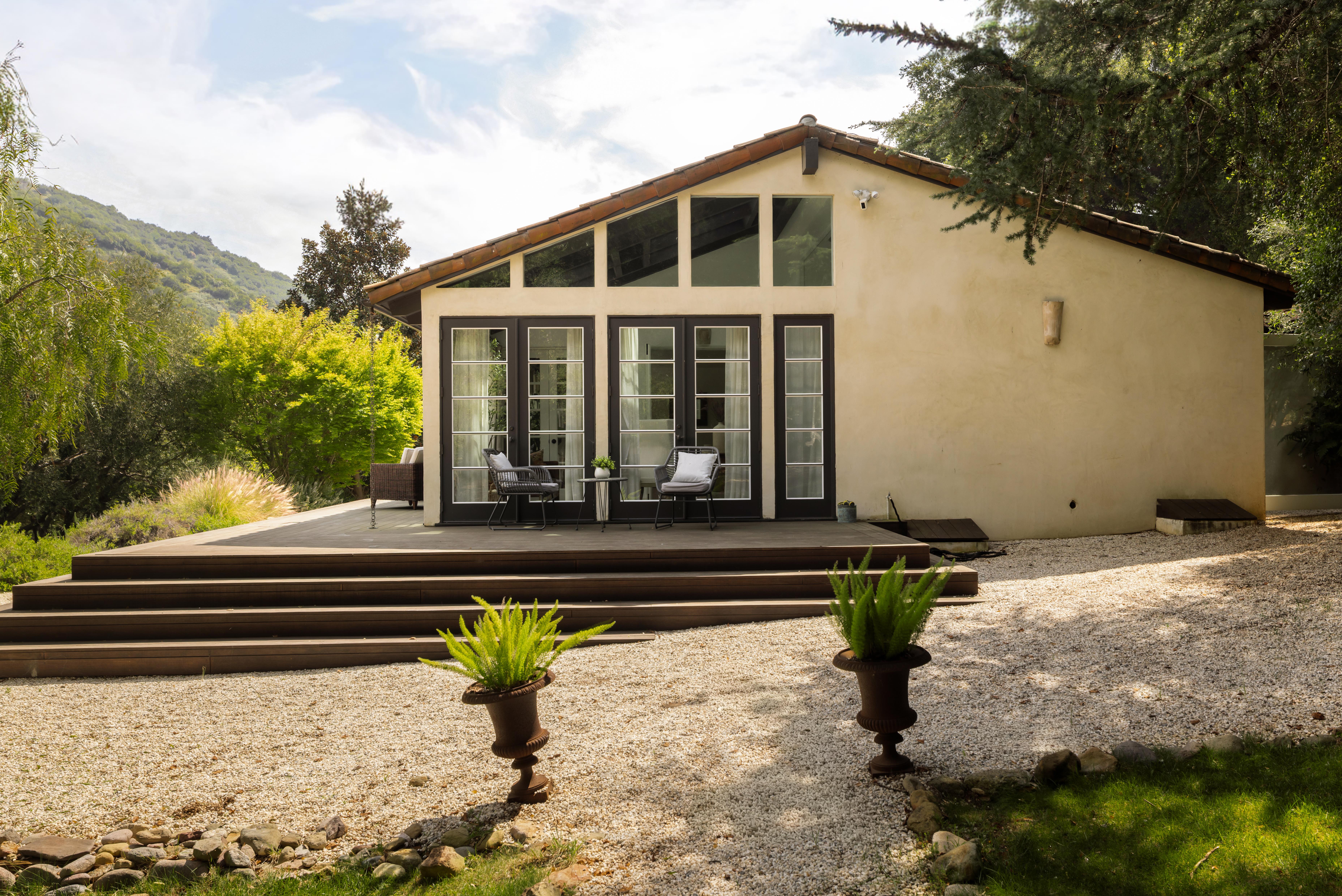Exterior facade of luxury canyon residence at 647 Old Topanga Canyon Rd, Topanga, CA — professional real estate photography by VirTour Media showcasing the natural integration of architecture and Southern California landscape. Our team captured still photography, a cinematic property video, a lifestyle video, an agent narration, a true vertical social media reel, and an FPV video tour throughout the midday.