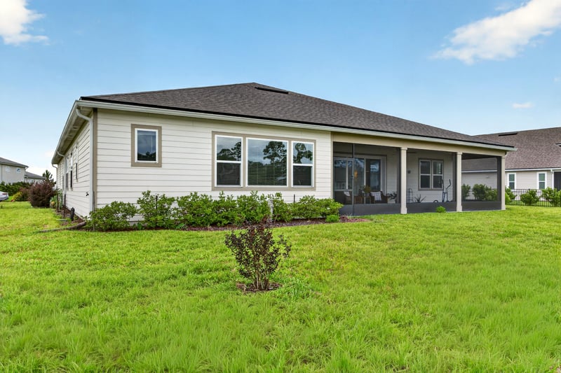 Rear exterior view with screened porch at 85491 Fall River Pkwy, Fernandina Beach, FL 32034