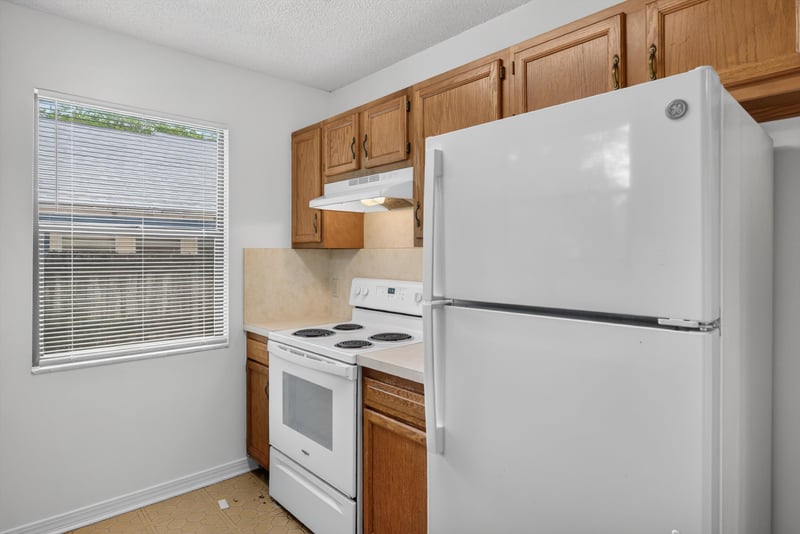 Kitchen with window and refrigerator at 1445 Classic Oak Rd W, Jacksonville, FL